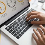 A freelancer using one of the best time tracking apps for freelancers on a laptop and phone