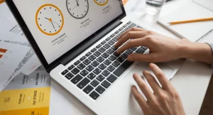 A freelancer using one of the best time tracking apps for freelancers on a laptop and phone
